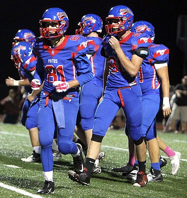 The California offense breaks the huddle early in the Pintos' game last Friday night against School of the Osage.