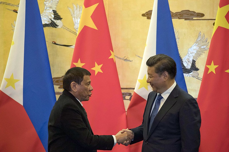 Philippine President Rodrigo Duterte, left, and Chinese President Xi Jinping shake hands after a signing ceremony in Beijing, China, Thursday, Oct. 20, 2016. Duterte was meeting Thursday with Xi in Beijing as part of a charm offensive aimed at seeking trade and support from the Asian giant by setting aside a thorny territorial dispute. 