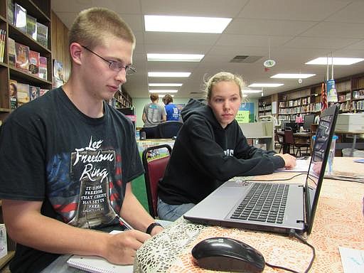 Emporia State University student Christianne Parks tutors Howard Brammell, 17, in math at the Allen, Kan., library Oct. 10, 2016. 