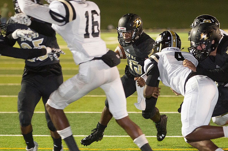 Pleasant Grove's TJ Cole weaves through the Pittsburg line Friday at Hawk Stadium in Texarkana, Texas.