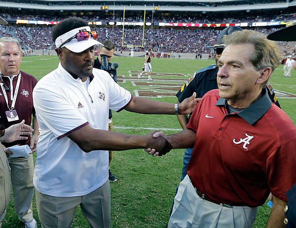 In this Oct. 17, 2015, file photo, Alabama coach Nick Saban (right) shakes hands with Texas A&M coach Kevin Sumlin following the Crimson Tides' 41-23 win in College Station, Texas. The sixth-ranked Aggies put their undefeated record on the line today against top-ranked Alabama, the SEC's other unbeaten team.