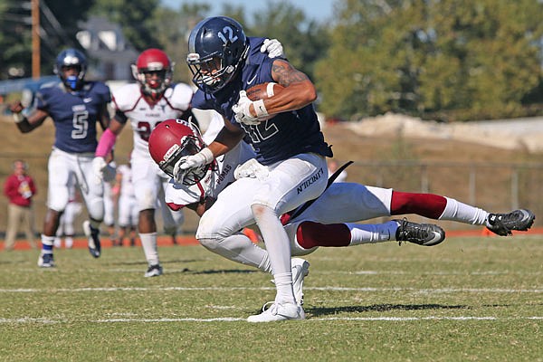 Lincoln wide receiver Anthony Townsend is tackled by a Saint Joseph's defender in a game earlier this month against the Pumas at Dwight T. Reed Stadium.