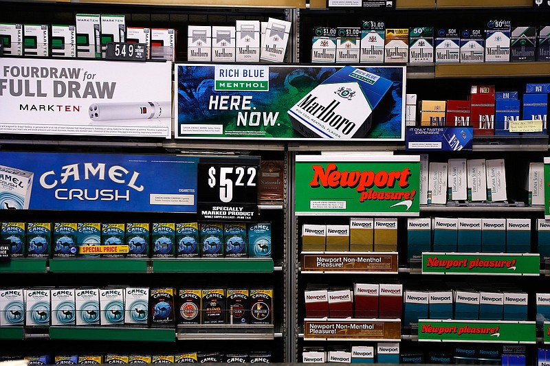In this Friday, July 17, 2015 file photo, Camel and Newport cigarettes, both Reynolds American brands, are on display at a Smoker Friendly shop in Pittsburgh. British American Tobacco offered Friday, Oct. 21 2016 to buy Reynolds American Inc. in a $47 billion cash-and-stock deal that would create the world's largest publicly traded tobacco company and bring together brands like Camel, Dunhill, and Newport. The logic of the deal, analysts say, is to make up for a decline in the number of smokers in their home markets of the U.S. and Britain as they look to developing markets and new products, such as electronic cigarettes.