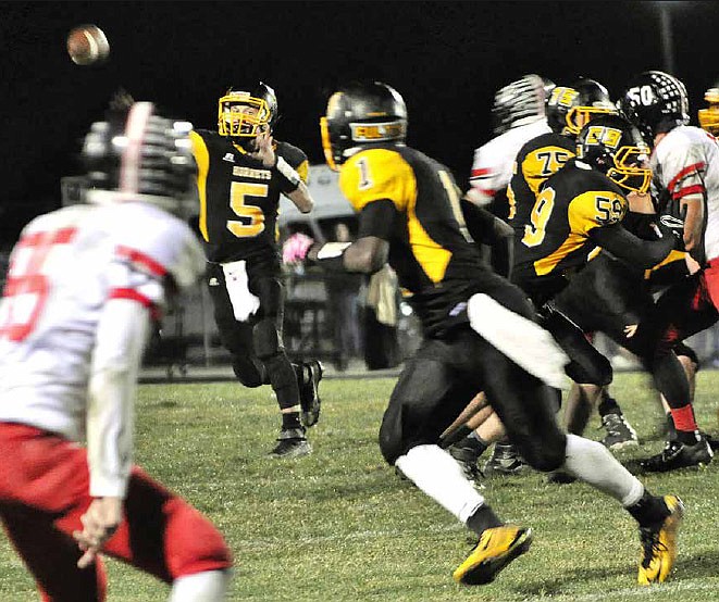 Fulton senior quarterback Devin Masek directs a pass toward junior wide receiver L'Trevion Vaughn (1) during the Class 3, District 6 first-round game Friday, Oct. 21, 2016 against Winfield at Robert E. Fisher Jr. Stadium. The Hornets pulled away for a 50-28 triumph over the Warriors.