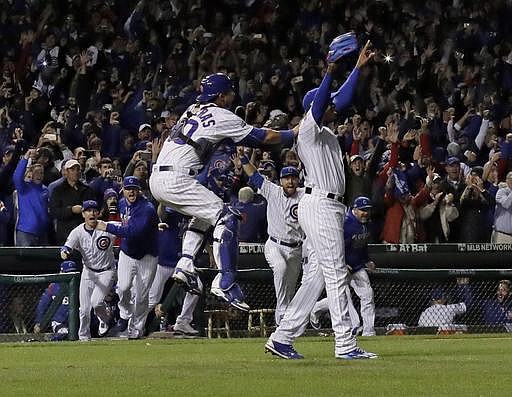 Chicago Cubs relief pitcher Aroldis Chapman (54) and catcher Willson Contreras (40) celebrate after Game 6 of the National League baseball championship series against the Los Angeles Dodgers, Saturday, Oct. 22, 2016, in Chicago. The Cubs won 5-0 to win the series and advance to the World Series against the Cleveland Indians. 