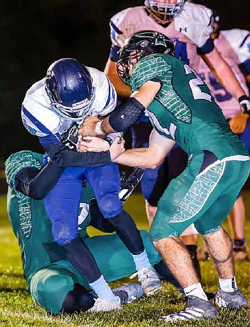 North Callaway senior defensive end Wyatt Branson tries to strip the ball from Tolton junior quarterback Steven Devine during the Class 2, District 5 first-round game Friday, Oct. 21, 2016 in Kingdom City. The No. 4 seed Thunderbirds had their season come to an end in a 31-14 loss to the No. 5 Trailblazers.