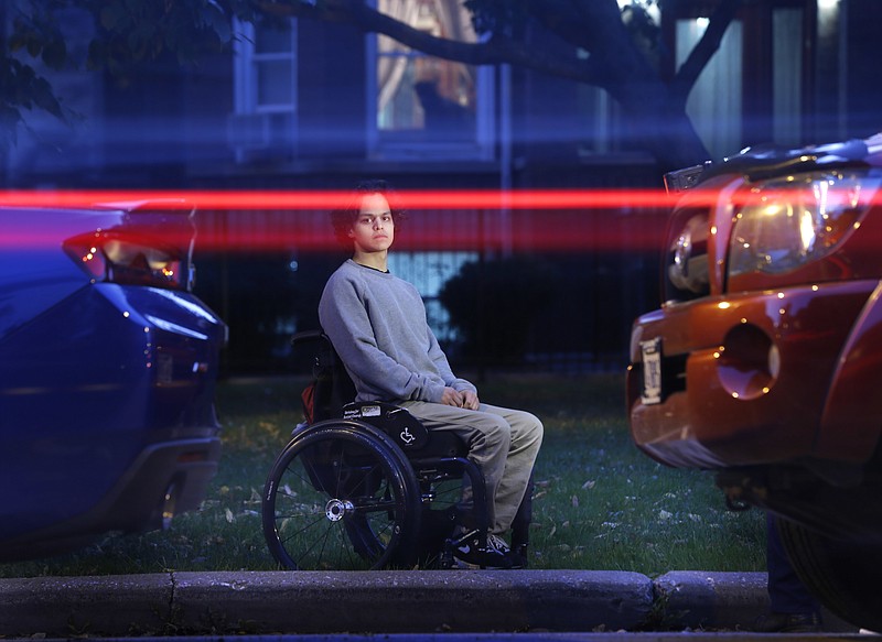 In this Thursday, Oct. 13, 2016 photo, vehicles pass by as Jonathan Annicks poses for a portrait in front of his home, just a few feet from where a gunman shot him while he was inside his brother's parked car in Chicago on April 10. He has little interest in the shooter. "If I lived with spite every day, then I don't think I would be able to function properly," he says. "I'd be very miserable if I were worrying about what he's doing or where he is. I don't think it's worth it." 