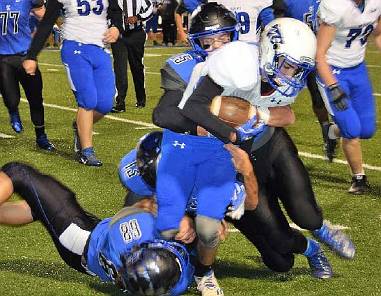 South Callaway sophomore free safety Peyton Leeper (15), junior linebacker Landon Horstman
(13) and senior defensive end Darrell Risch (68) team up to tackle a Montgomery County
ball carrier Friday night, Oct. 21, 2016 in a Class 2, District 5 first-round matchup in Mokane. The ninth-ranked Bulldogs breezed to a 60-12 blitz of the Wildcats.