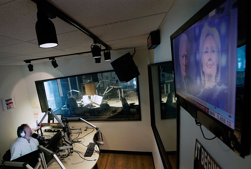 Images of Republican and Democratic presidential candidates Donald Trump and Hillary Clinton are displayed on a television screen in the studio of radio talk show host Rick Roberts during his program in Dallas. The station estimates Roberts' audience is about two-thirds male and overwhelmingly white, though women and minorities also call in, and you needn't look far, even in Roberts' own studio, to find a white man who doesn't subscribe to conservative orthodoxy.