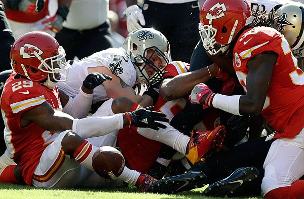 Chiefs teammates Eric Berry (left) and Ron Parker (right) scramble for a fumble along with Josh Hill of the Saints during Sunday's game at Arrowhead Stadium. The Chiefs recovered the ball.