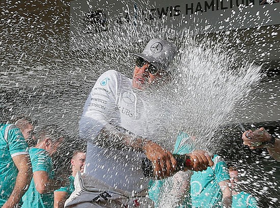 Lewis Hamilton celebrates with team members Sunday after winning the Formula One U.S. Grand Prix at the Circuit of the Americas in Austin, Texas.