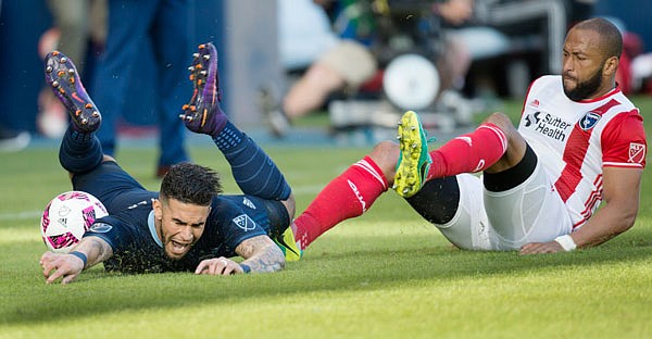 Sporting Kansas City forward Dom Dwyer reacts after being knocked down by San Jose Earthquakes defender Victor Bernardez during the second half of Sunday's game in Kansas City, Kan.