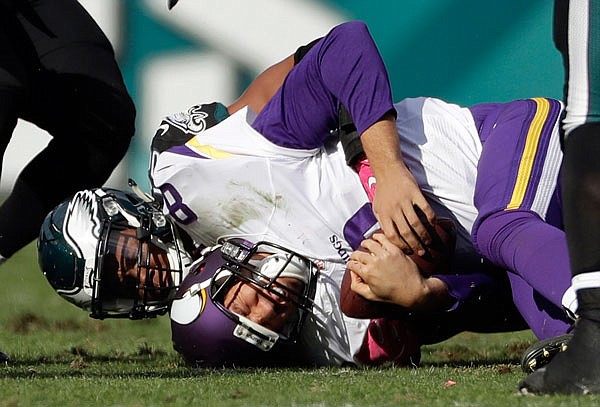 Vikings quarterback Sam Bradford is tackled by Jordan Hicks of the Eagles during the second half of Sunday's game in Philadelphia.