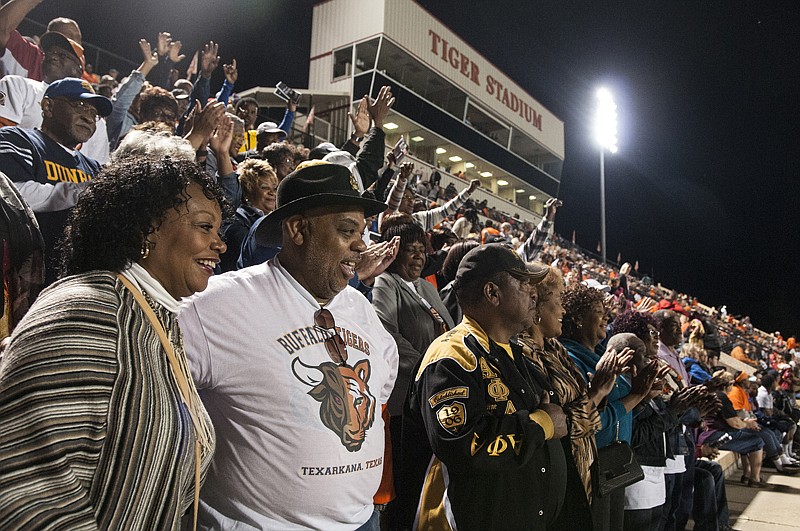 Rita Haywood-Wiggins, left, and Tony Patterson, center, stand with other members of the Dunbar High School National Alumni Association in honor of the late Dan Haskins. "Dan was my coach growing up, and there will never be another man like him," Patterson said. 
