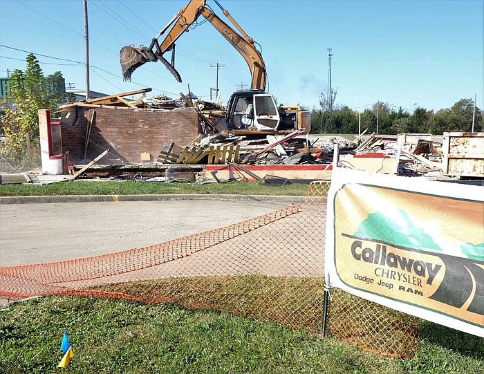 The bulding on Business 54 which formerly housed the Golden Corral is torn down Monday. The adjacent Callaway Chrysler will expand onto the property.