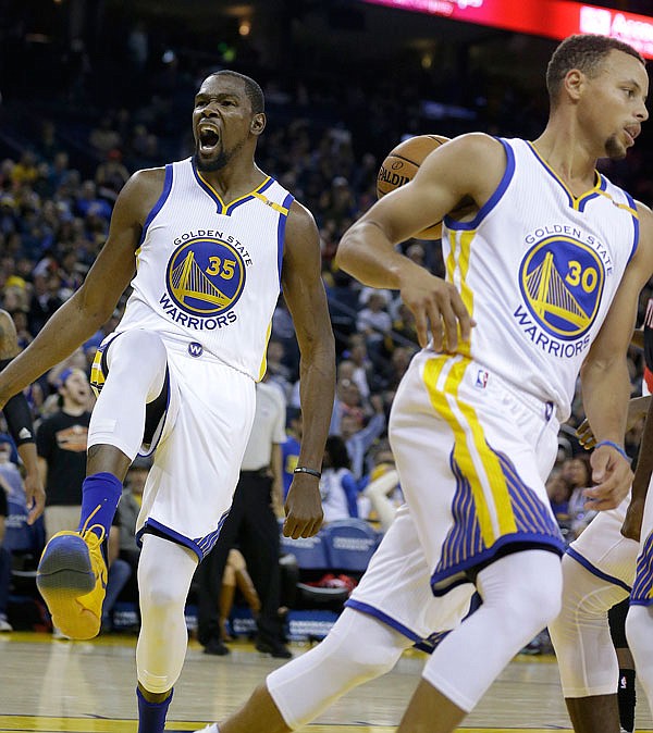 Kevin Durant of the Warriors celebrates after scoring against the Trail Blazers during the second half of Friday's preseason game in Oakland, Calif.