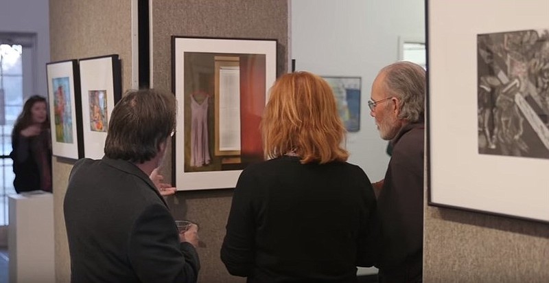 This photo taken from video shows people enjoying the Small Works on Paper exhibit.
Submitted photo