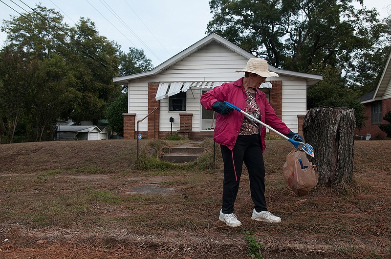 Elizabeth Anne Cooney cleans up the road and sidewalk around her home Tuesday on Hickory Street.  "Growing up I lived in both Texarkana, Ark., and Texarkana, Texas, I feel like a true Texarkana girl," Cooney said.