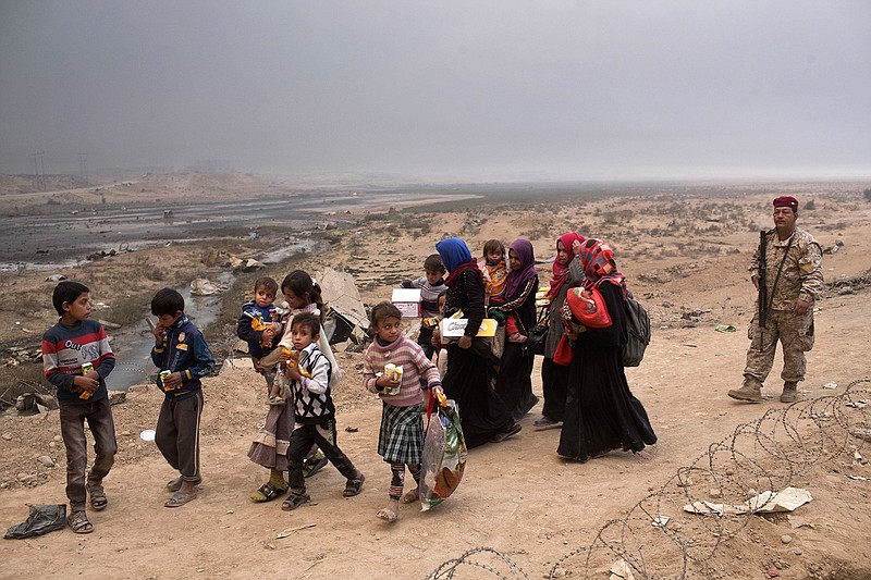 Internally displaced persons clear a checkpoint in Qayara, some 50 kilometers south of Mosul, Iraq, Wednesday, Oct. 26, 2016. Islamic State militants have been going door to door in farming communities south of Mosul, ordering people at gunpoint to follow them north into the city and apparently using them as human shields as they retreat from Iraqi forces. Witnesses to the forced evacuation describe scenes of chaos as hundreds of people were driven north across the Ninevah plains and into the heavily-fortified city, where the extremists are believed to be preparing for a climactic showdown. 