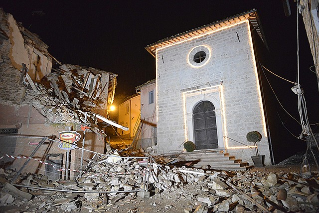 The Church of San Sebastiano stands amidst damaged houses Wednesday in Castelsantangelo sul Nera, Italy, following an earthquake. A pair of strong aftershocks shook central Italy late Wednesday, crumbling churches and buildings, knocking out power and sending panicked residents into the rain-drenched streets just two months after a powerful earthquake killed nearly 300 people.