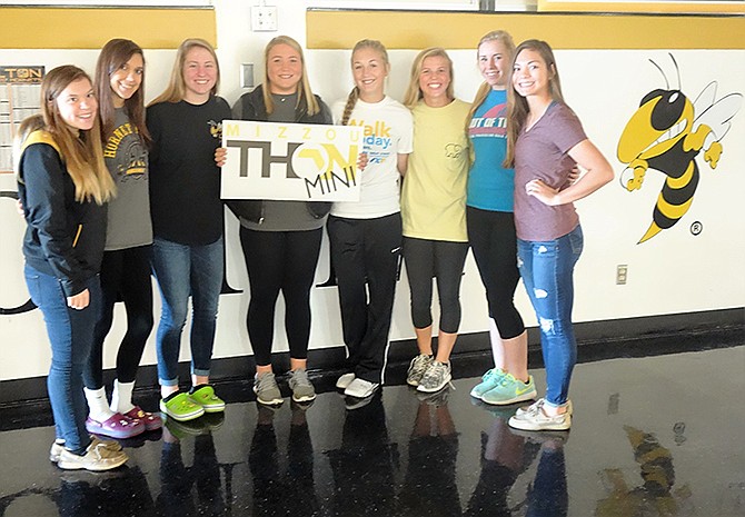 A group of students show off a sign Monday promoting Mizzouthon. As part of the events, students from Fulton High School are raising funds for the University of Missouri Children's Hospital.