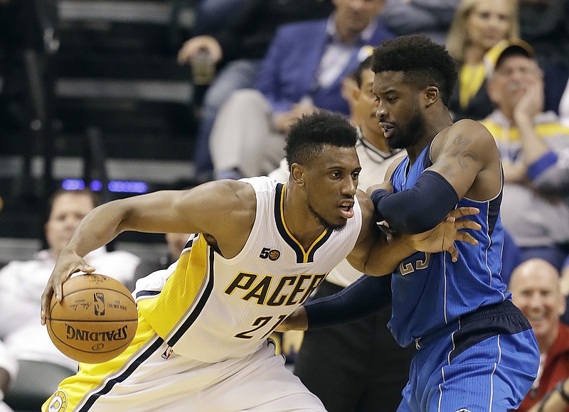 Indiana Pacers' Thaddeus Young goes to the basket against Dallas Mavericks' Wesley Matthews during the first half of an NBA basketball game Wednesday, Oct. 26, 2016, in Indianapolis. 