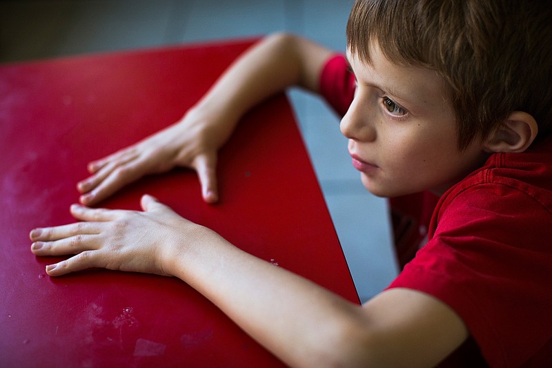 Steven Smith, 11, is pictured in a Wednesday, Oct. 5, 2016 photo, in Leander, Texas. Steven has had over 10 surgeries to build a functional hand because he was born without any thumbs nor the basic hand bones. He was also born with autism. Steven Smith's parents struggled to obtain special education services for autism and orthopedic impairment. some schools across Texas have ousted children with disabilities from needed services in order to comply with an agency decree that no more than 8.5 percent of students should obtain specialized education.