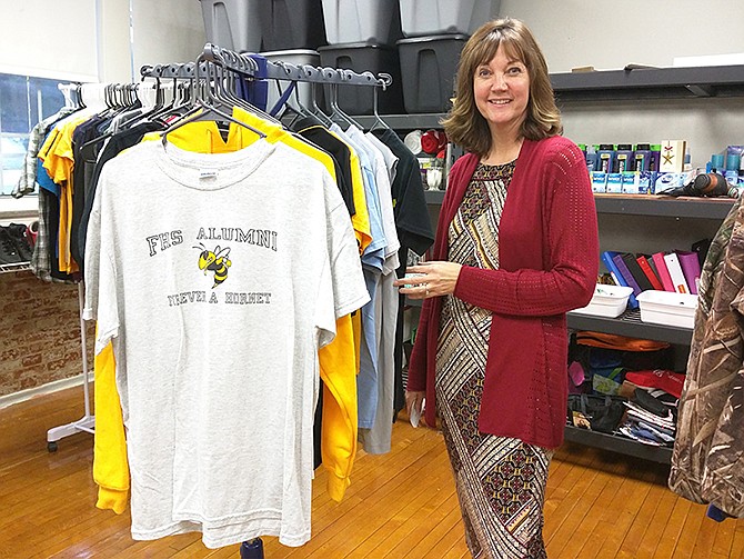 Corine Tobias shows off the goods available to students at Fulton Middle School's Thrive Hive.