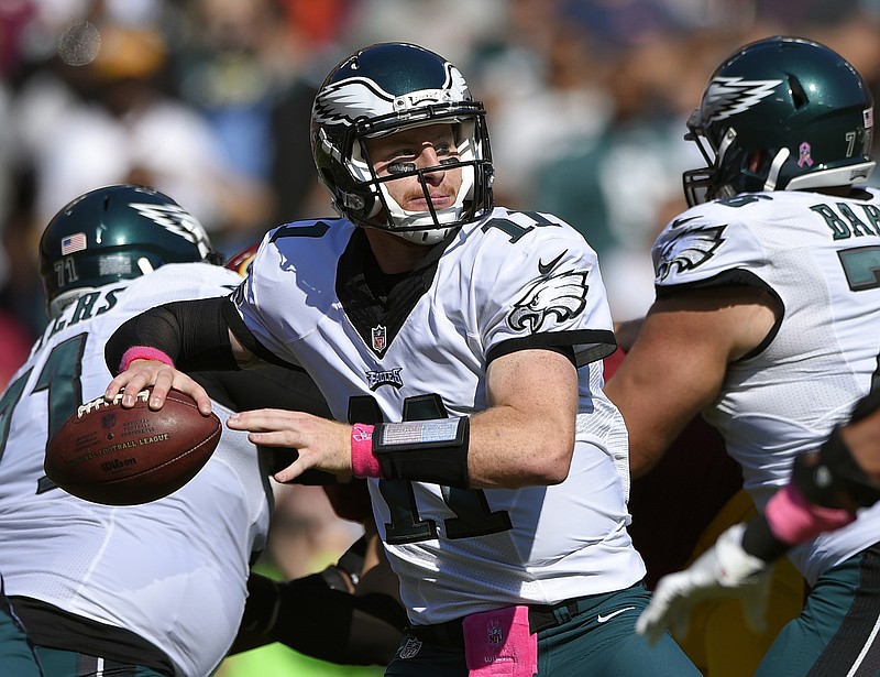 In this Sunday, Oct. 16, 2016, file photo, Philadelphia Eagles quarterback Carson Wentz throws to a receiver in the first half of an NFL football game against the Washington Redskins in Landover, Md. Wentz leads NFL rookies with eight passing TDs.