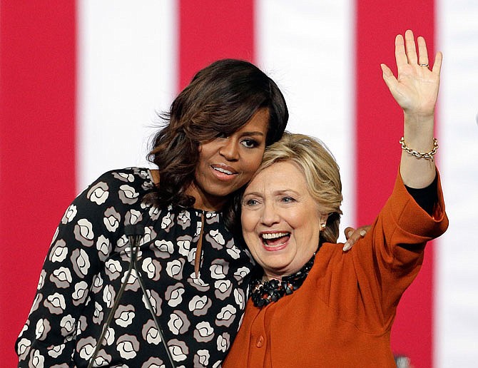 Democratic presidential candidate Hillary Clinton is hugged by first lady Michelle Obama during a campaign rally Thursday in Winston-Salem, North Carolina.