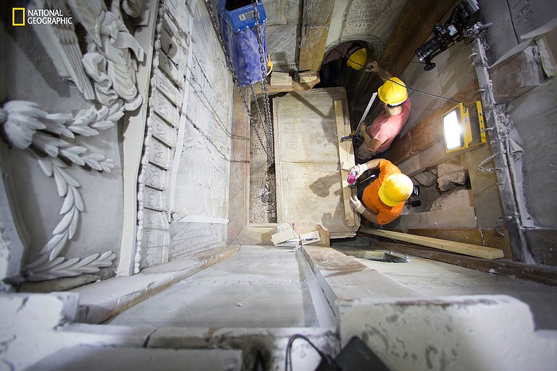 This Wednesday Oct. 26, 2016 photo, shows the moment workers remove the top marble layer of the tomb said to be of Jesus Christ, in the Church of Holy Sepulcher in Jerusalem. A restoration team has peeled away a marble layer for the first time in centuries in an effort to reach what it believes is the original rock surface where Jesus' body was laid.