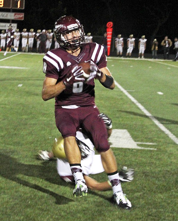 Osage senior wideout Jason Edwards catches a pass against Eldon in Tri-County Conference play earlier this month in Osage Beach. The two rivals will meet again tonight in the Class 3 District 3 semifinals.