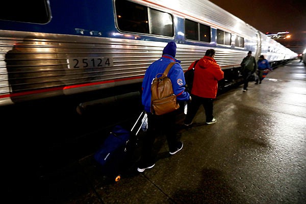 AP
Cubs fan Marvin Thomas (foreground) boards the train early Thursday in Cleveland after Game 2 of the World Series. Only about two dozen Cubs fans boarded Amtrak's Lake Shore Limited trains 49/449 at 3:45 a.m. for the 341-mile trip to Chicago's Union Station.