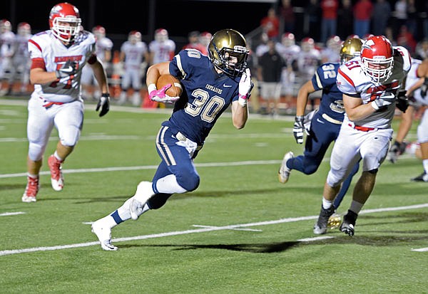 Crusaders running back Blake Veltrop of Helias for a touchdown in Helias' district game against Warrenton at Adkins Stadium on Friday