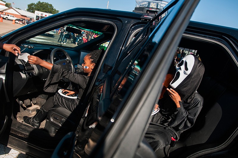 Tyran Holmes, right, and Alexis Threadgill explore a Texarkana, Texas, Police Department patrol car Friday  during the "Day With the Law" Fall Festival at Liberty-Eylau High School. 