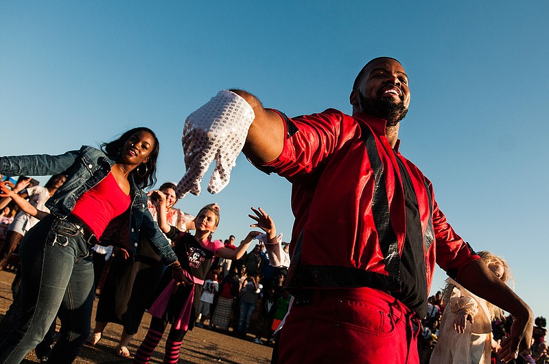 Greg Williams, playing Michael Jackson, leads the "Thriller" flash mob Saturday at the 2016 Fall Festival in downtown Texarkana. 