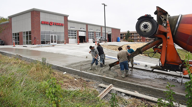 The construction of the new Jefferson City location of Big O Tires at 1614 Jefferson St. nears completion in advance of its Oct. 31, 2016 planned opening. Concrete workers from Brett Stevens Construction in Marshfield are seen working on the final segment of the freshly-poured cement on the driveway.