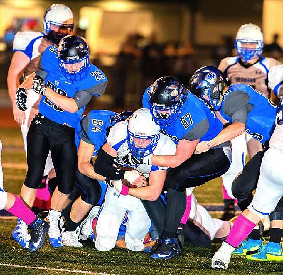 South Callaway junior defensive end Hunter Schroer takes Hermann senior quarterback Garrett Leimkuehler to the ground during the Bulldogs' 26-20 loss to the Bearcats in the Class 2, District 5 semifinals Friday night in Mokane, Mo.