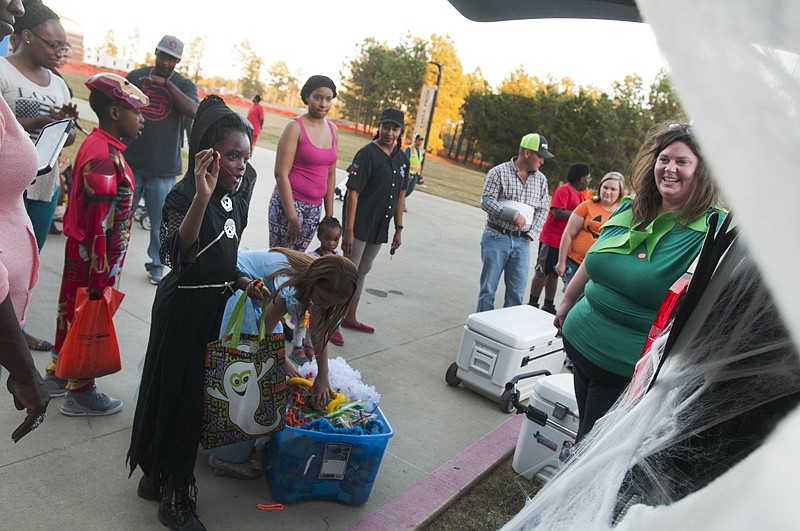 Rahniyah Davis, left, plays games for candy and toys Monday during the annual Trunk or Treat Celebration at Texas A&M University-Texarkana.