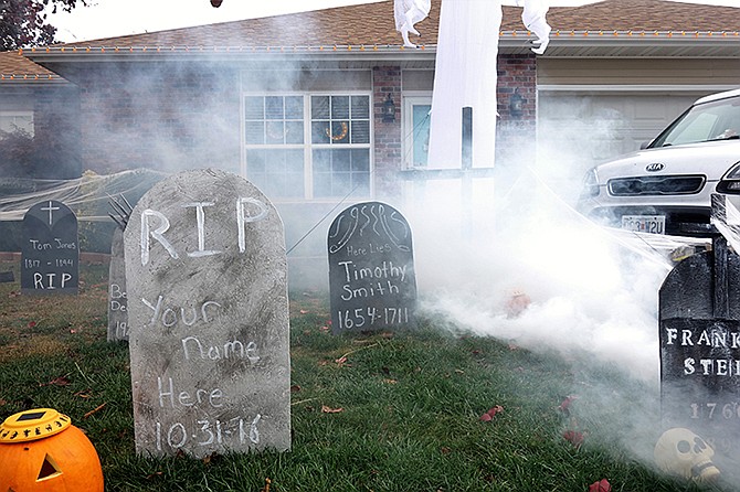 The Strother family in Fulton fire up their fog machine Monday morning in preparation for the trick-or-treaters last night.