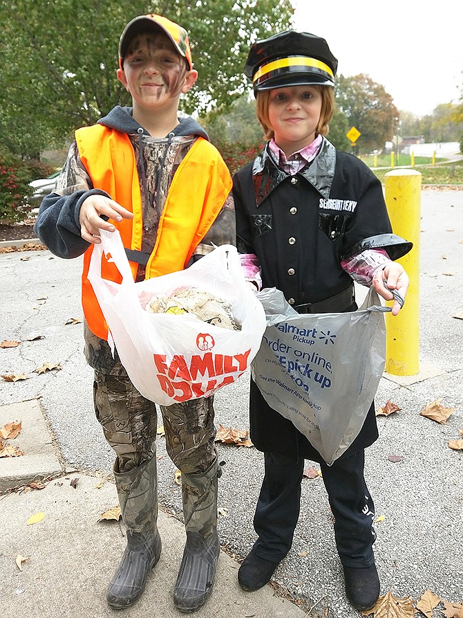 Gabe O'Neil, left, and Shelby Ward gathered a total of four bags of trash together at the Scream Clean event.