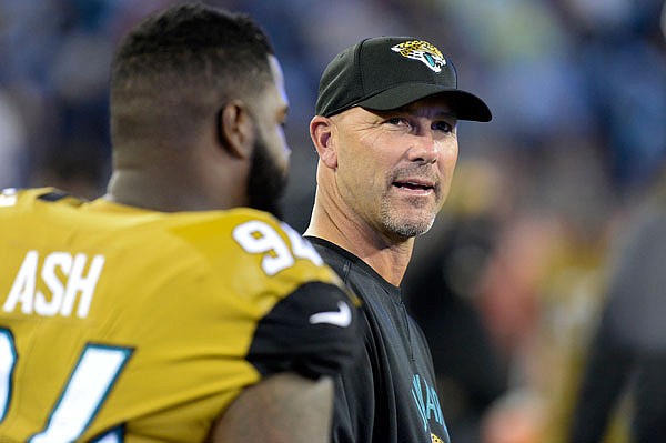 Jaguars head coach Gus Bradley and defensive lineman Richard Ash watch from the sideline during the second half of last Thursday night's game against the Titans in Nashville, Tenn.