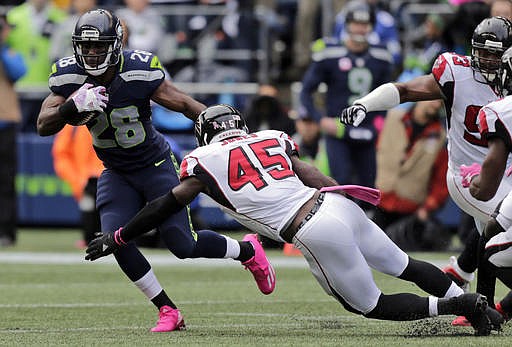 In this Oct. 16, 2016, file phot, Seattle Seahawks running back C.J. Spiller (28) is tackled by Atlanta Falcons strong middle linebacker Deion Jones (45) during the first half of an NFL football game against the Atlanta Falcons in Seattle. 