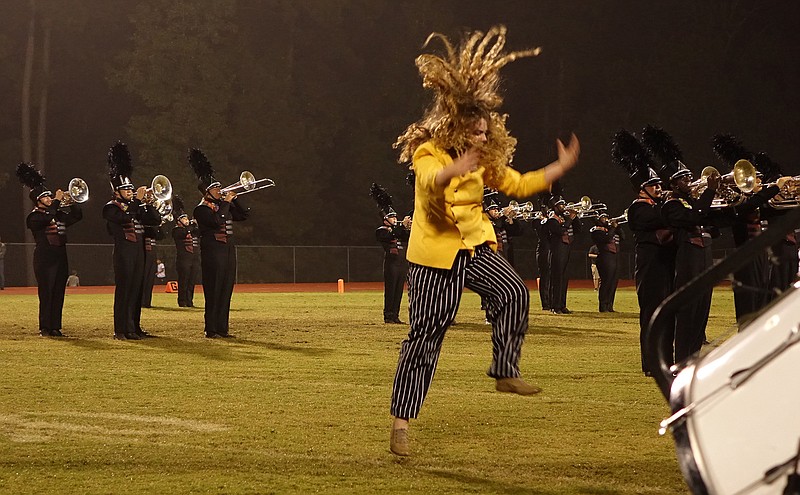 Mary Katie Tigert's outlandish display during the Atlanta High Rabbit Band's marching halftime program certainly merits the term "mad-hatter" that she is given. The band's program is described as "It's a Mad, Mad World." This photo also shows the band's new uniforms that recently arrived.