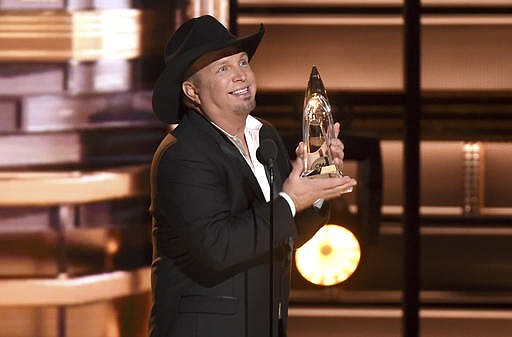 Garth Brooks accepts the award for entertainer of the year at the 50th annual CMA Awards at the Bridgestone Arena on Wednesday, Nov. 2, 2016, in Nashville, Tenn.