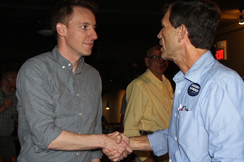 From left, Missouri Secretary of State Jason Kander, candidate for U.S. Senate, and Ed Lockwood, candidate for the Missouri House of Representatives, shake hands at Bek's on Wednesday.