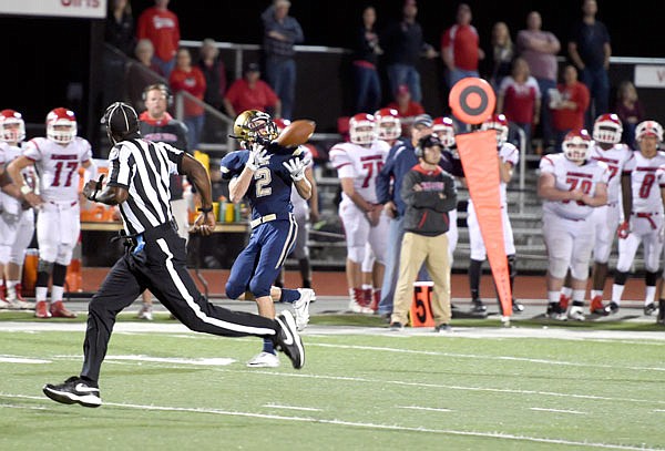 Dalton Weaver of Helias catches what turns into a 67-yard touchdown pass during last Friday night's game against Warrenton at Adkins Stadium.