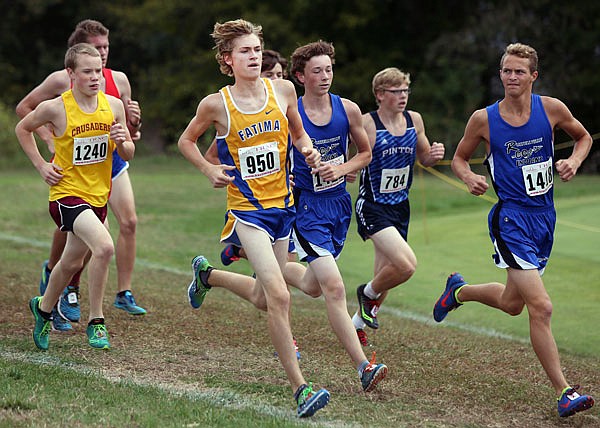 Anthony Bertucci of Russellville (1418) takes a look to his right as Dalton Luebbert of Fatima (950) runs alongside during last month's Capital City Cross Country Challenge at the Oak Hills Golf Center.