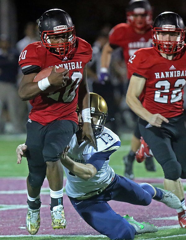 Sam Heckart of Helias brings down Shamar Griffith of Hannibal to save a touchdown on a kickoff return during Friday night's Class 4 District 7 championship game in Hannibal.