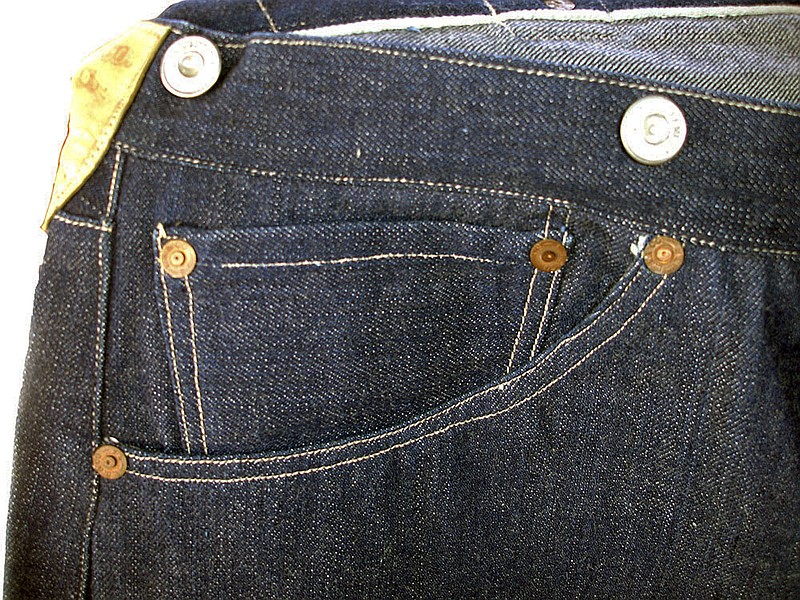 This undated photo provided by Daniel Buck Auctions & Appraisals shows the right front pocket on a pair of 1893 Levi-Strauss denim blue jeans in pristine condition that will go up for auction Saturday, Nov. 5, 2016 in Lisbon Falls, Maine. The auction house said the jeans were ordered for Solomon Warner, a businessman and pioneer who participated in the creation of the Arizona Territory. Warner wore them only a few times before falling ill. He died in 1899. 
